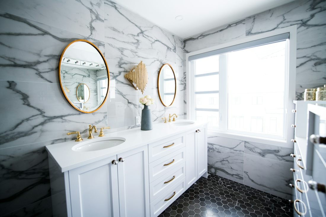 Renovated bathroom with double vanity and large mirror