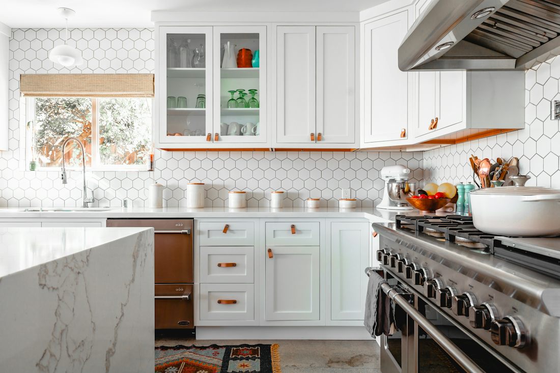 Bright kitchen with white cabinets and tiled backsplash